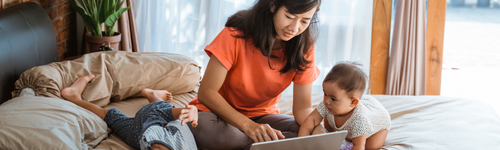 Mom at home with kids using laptop